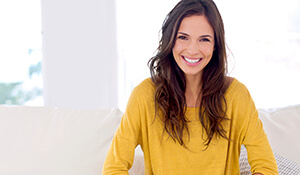 Woman in yellow smiling brightly